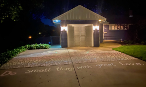 Image of a house, with a chalk drawing of hearts and the caption "Do small things with great love."