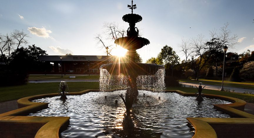 The fountain at sunrise with Maxwell Theatre in the distance.