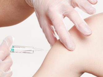 A nurse injecting a needle in a patient's arm