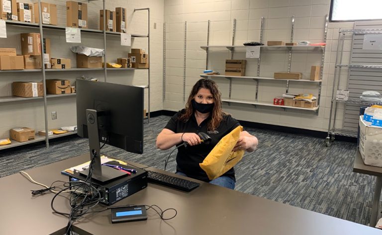 woman scans a mail package