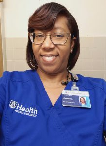 Woman in scrubs smiling