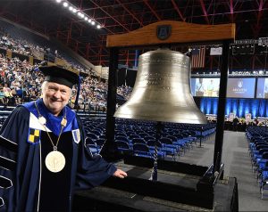 Man beside large bell