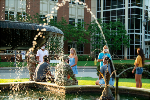 people standing near fountain