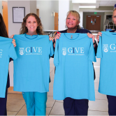 women holding shirts