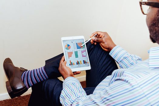 man holding iPad and stylus