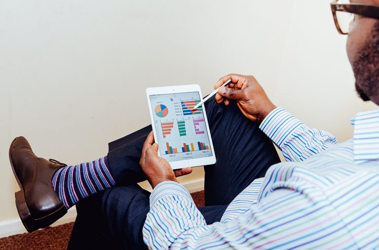 man holding iPad and stylus
