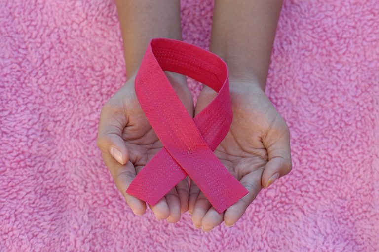 Hands holding breast cancer ribbon