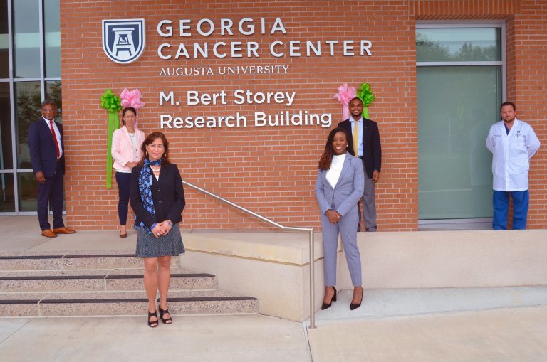 A group of people standing in front of a building