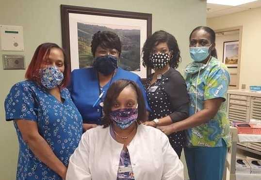 five nurses in scrubs