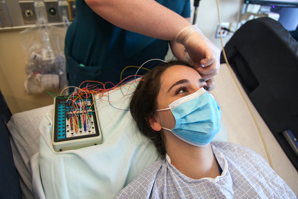 Woman has electrodes placed on her head