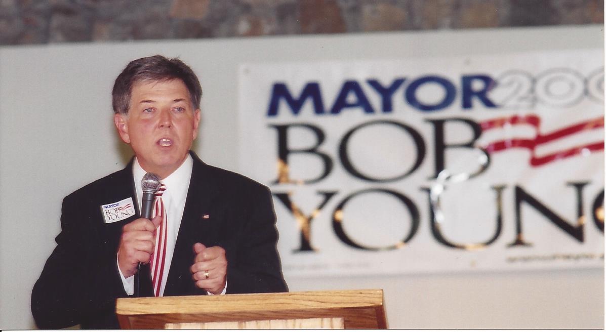 politician in front of sign