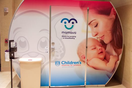 lactation pod next to trash can and hand sanitizer station