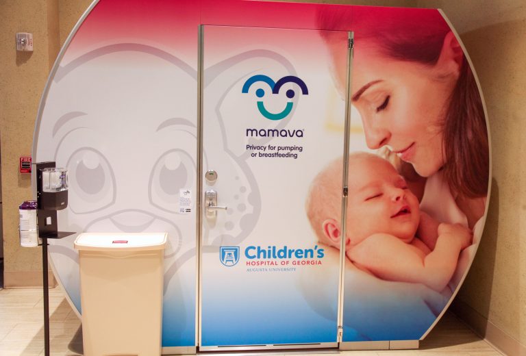 lactation pod next to trash can and hand sanitizer station