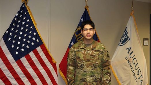 Man in front of flags