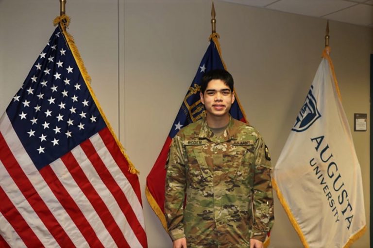 Man in front of flags