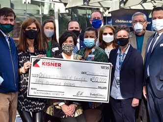 A group of people posing with a large check.