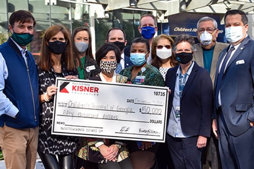 A group of people posing with a large check.