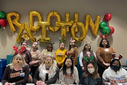 people in front of radiothon balloon sign