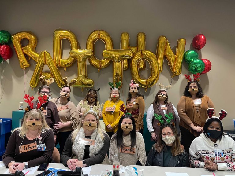 people in front of radiothon balloon sign