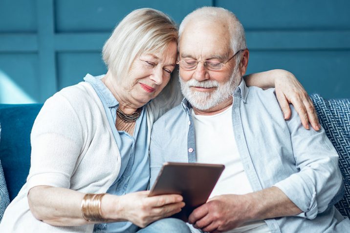 Senior couple with tablet at home