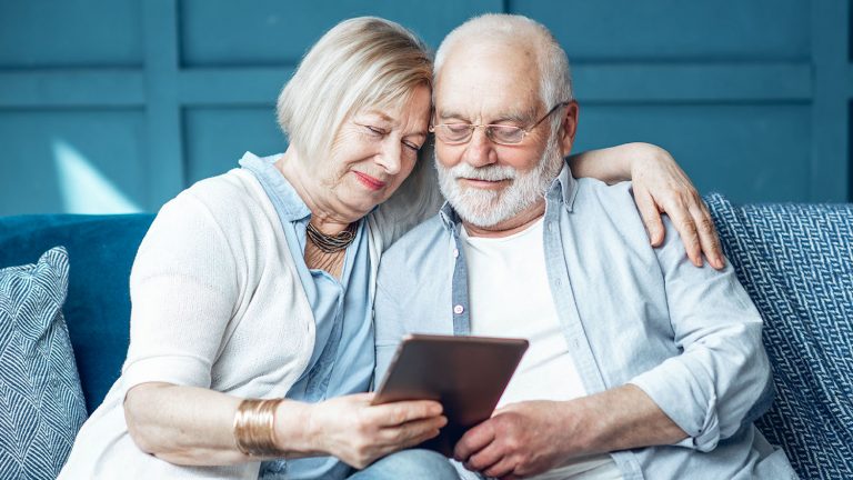 Senior couple with tablet at home