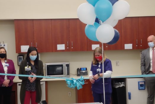 two women cut ribbon