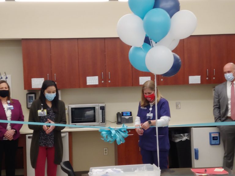 two women cut ribbon