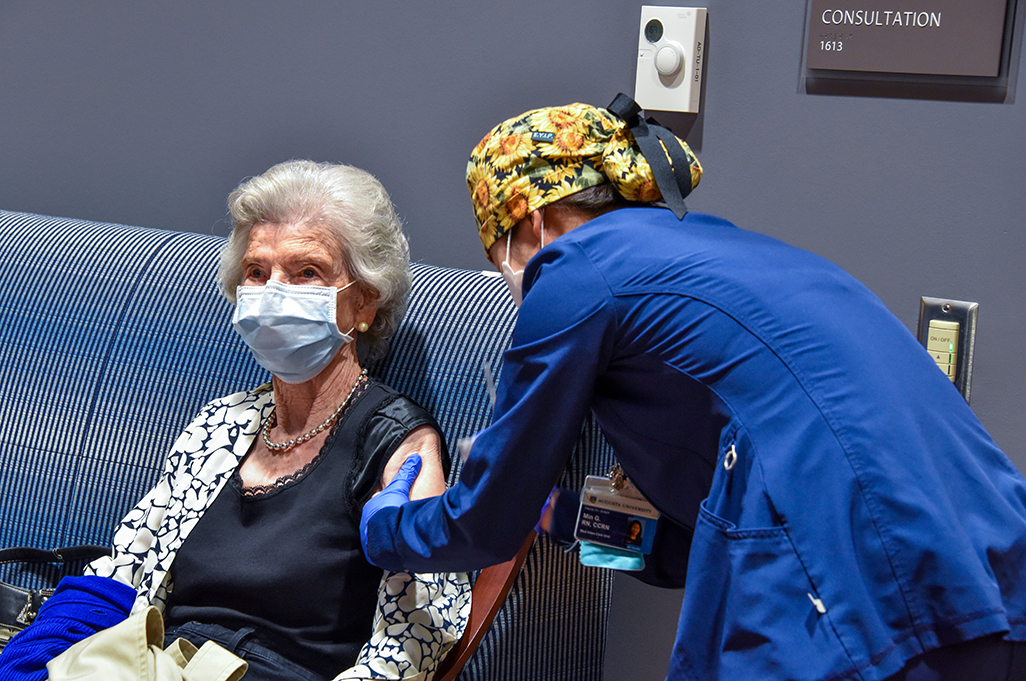 Nurse giving a woman a shot