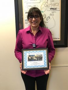 Woman holding plaque