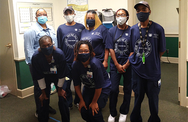 seven coworkers in blue shirts