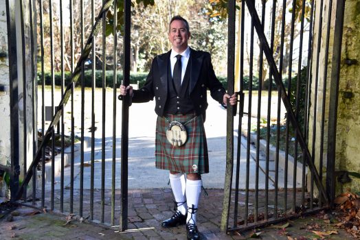 man smiling wearing a kilt