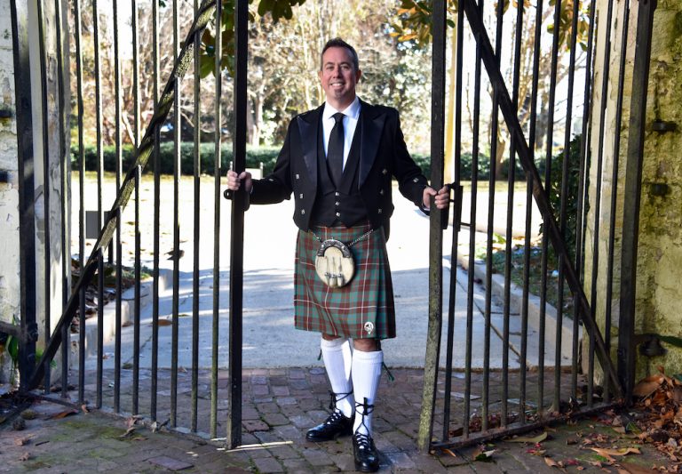 man smiling wearing a kilt