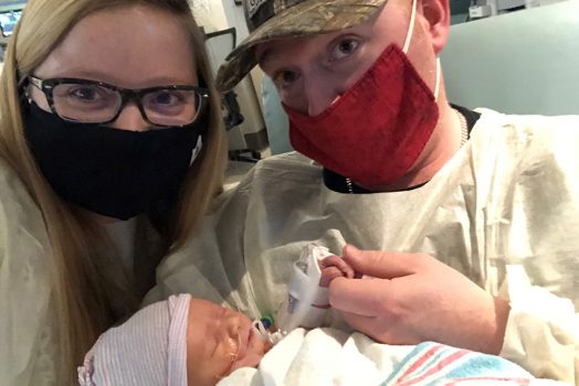 Parents holding baby