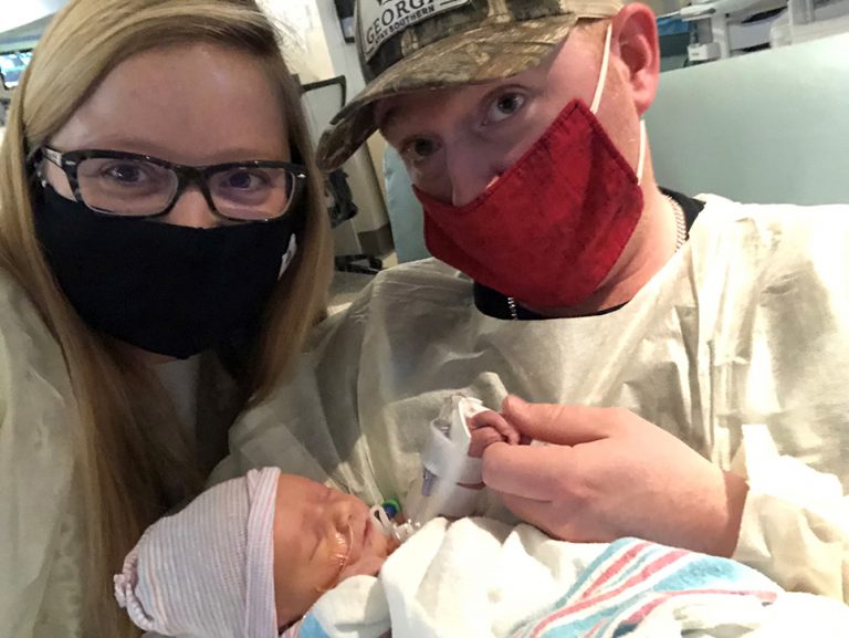 Parents holding baby