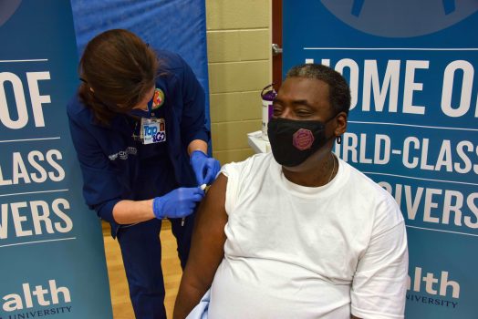 woman places bandage on man