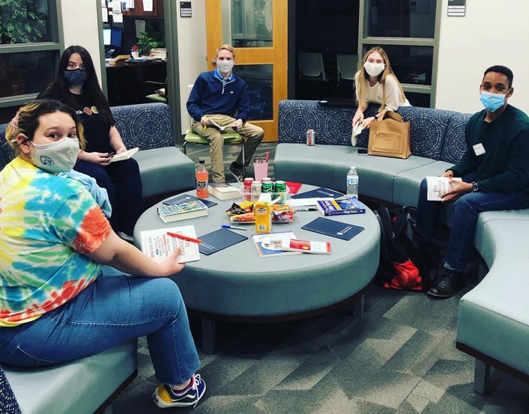 Five students sitting in a circle
