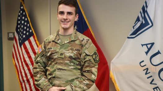 Man standing in front of flags