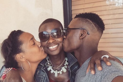 Two teen kids kissing mom on the cheek