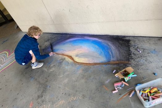 boy making chalk drawing