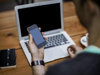 Person with phone, laptop