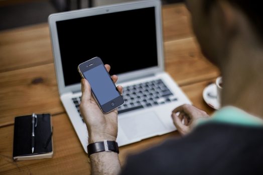Person with phone, laptop