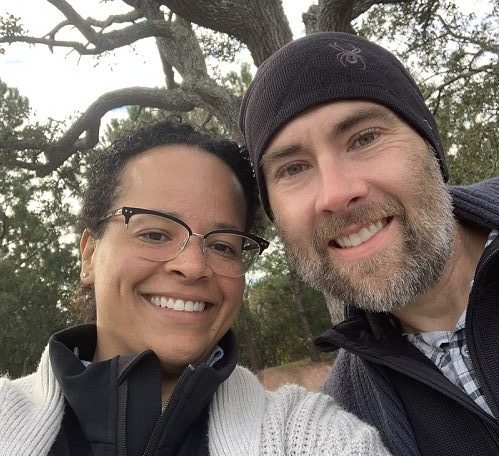 woman and man in front of tree