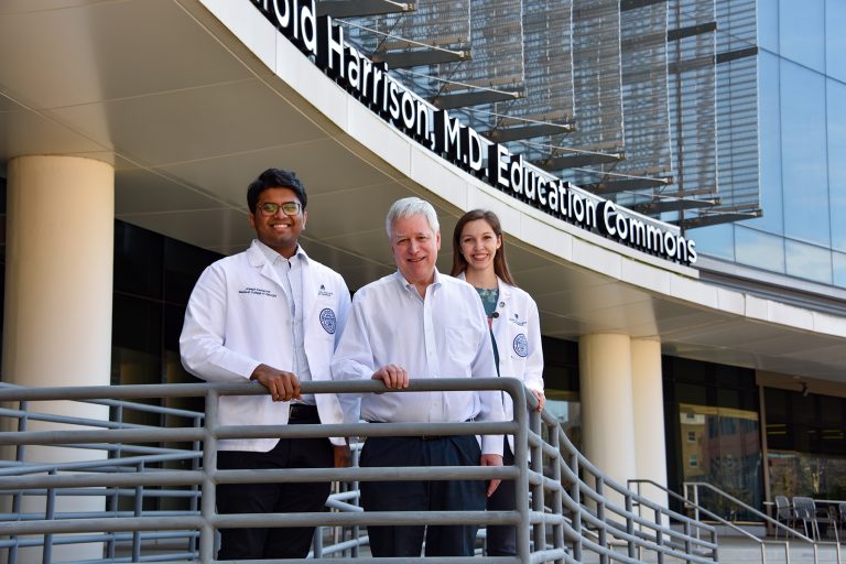 Photo of students and Dr. Rodger MacArthur in front of the Harrison Commons