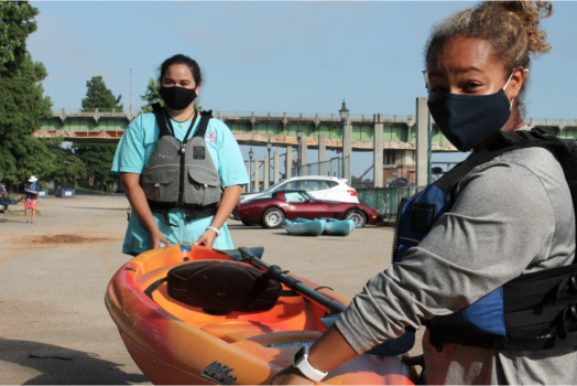 woman carrying boat
