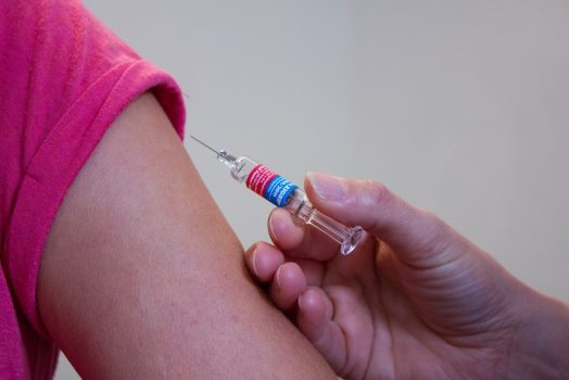Someone getting an injection in their arm