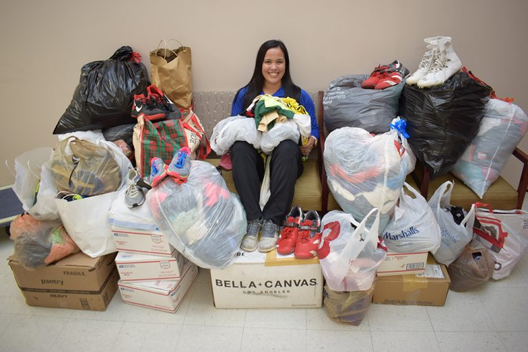 Woman surrounded by bags of clothes