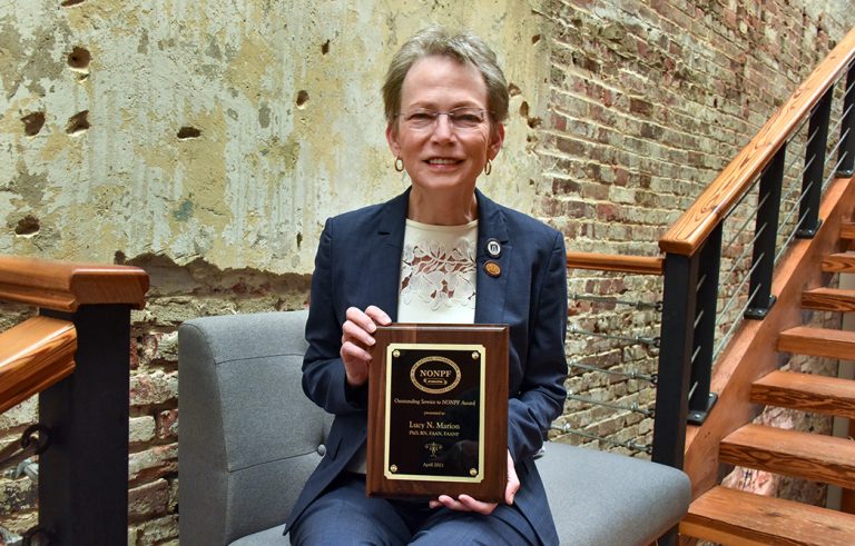 Woman holding a plaque