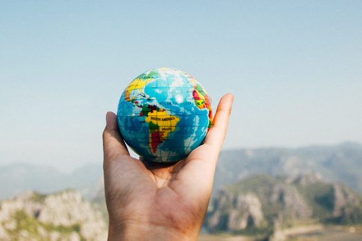 Person with globe in hand