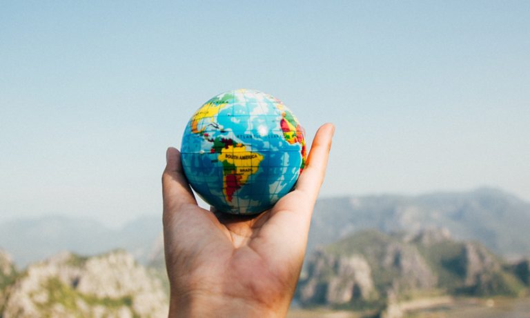 Person with globe in hand