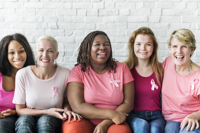 women wearing pink ribbons
